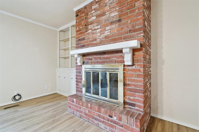 3119 W Wilshire Blvd, Oklahoma City, OK 73116 - unfurnished living room with wood finished floors, baseboards, a brick fireplace, crown molding, and built in features