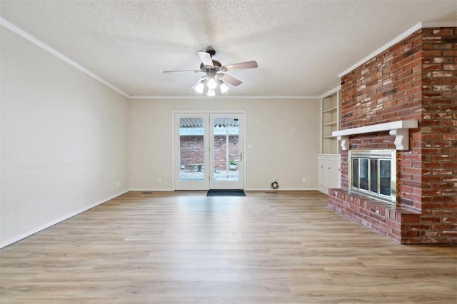3119 W Wilshire Blvd, Oklahoma City, OK 73116 - unfurnished living room with a ceiling fan, a textured ceiling, wood finished floors, a brick fireplace, and crown molding