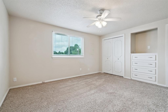 3119 W Wilshire Blvd, Oklahoma City, OK 73116 - unfurnished bedroom with a textured ceiling, carpet floors, a closet, and baseboards
