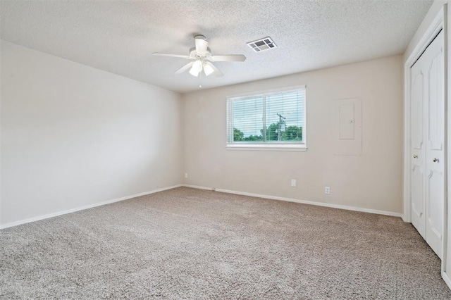 3119 W Wilshire Blvd, Oklahoma City, OK 73116 - unfurnished bedroom featuring carpet flooring, a closet, a textured ceiling, baseboards, and a ceiling fan