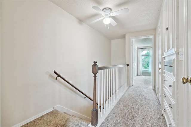 3119 W Wilshire Blvd, Oklahoma City, OK 73116 - hallway with an upstairs landing, carpet flooring, a textured ceiling, and baseboards