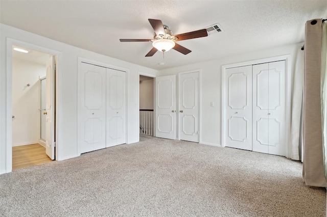 3119 W Wilshire Blvd, Oklahoma City, OK 73116 - unfurnished bedroom with carpet floors, two closets, connected bathroom, and baseboards