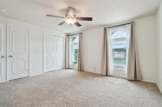 3119 W Wilshire Blvd, Oklahoma City, OK 73116 - unfurnished bedroom with a textured ceiling, carpet, a ceiling fan, and baseboards