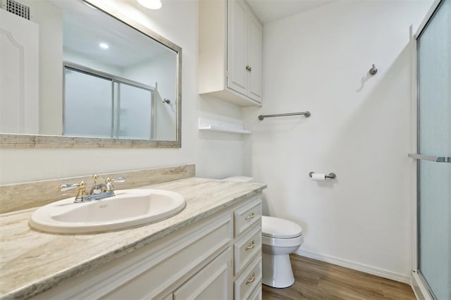 3119 W Wilshire Blvd, Oklahoma City, OK 73116 - bathroom featuring toilet, a shower stall, vanity, and wood finished floors
