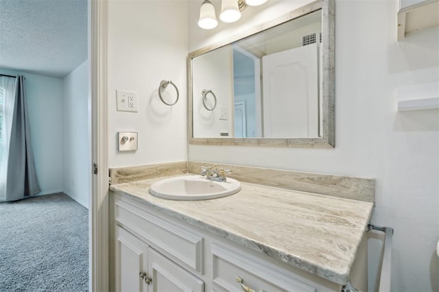 3119 W Wilshire Blvd, Oklahoma City, OK 73116 - bathroom with vanity and a textured ceiling
