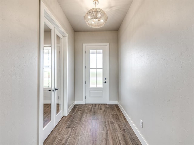 6841 Lake View Ct, Cashion, OK 73016 - doorway with plenty of natural light, dark wood-style floors, baseboards, and a textured wall
