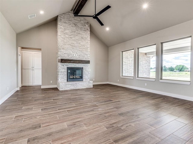 6841 Lake View Ct, Cashion, OK 73016 - unfurnished living room with ceiling fan, a fireplace, beam ceiling, baseboards, and high vaulted ceiling