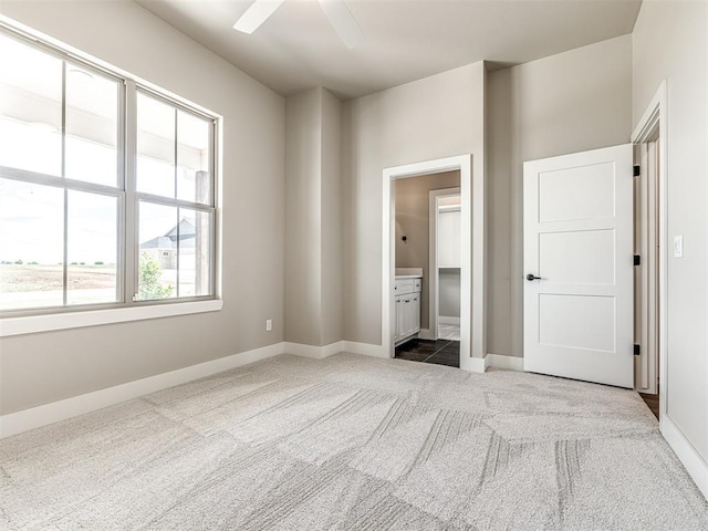 6841 Lake View Ct, Cashion, OK 73016 - unfurnished bedroom featuring carpet, baseboards, ensuite bathroom, and a ceiling fan