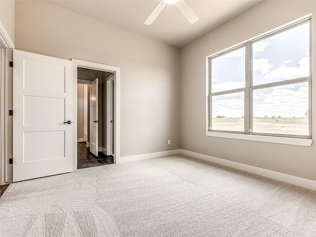 6841 Lake View Ct, Cashion, OK 73016 - unfurnished bedroom with dark carpet, baseboards, and ceiling fan