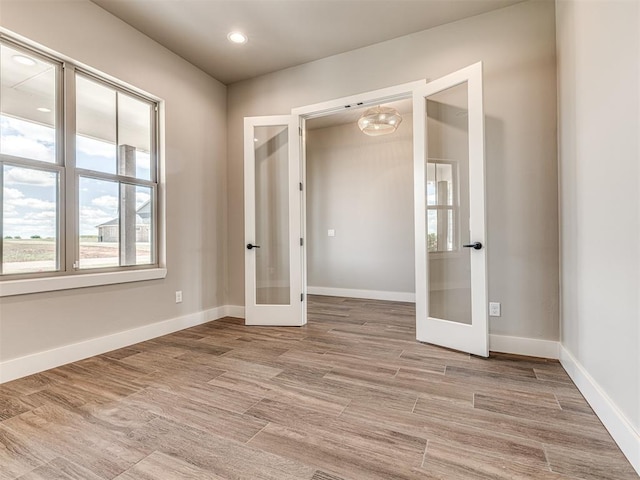 6841 Lake View Ct, Cashion, OK 73016 - unfurnished room with french doors, baseboards, light wood-type flooring, and recessed lighting