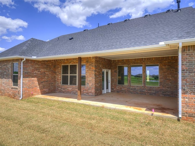 6841 Lake View Ct, Cashion, OK 73016 - back of house featuring a shingled roof, a lawn, a patio, and brick siding