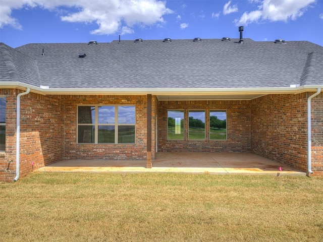 6841 Lake View Ct, Cashion, OK 73016 - rear view of house featuring a patio, a shingled roof, brick siding, and a lawn