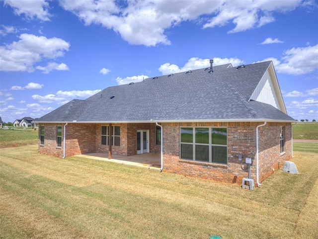 6841 Lake View Ct, Cashion, OK 73016 - back of house with a shingled roof, brick siding, a patio area, and a yard