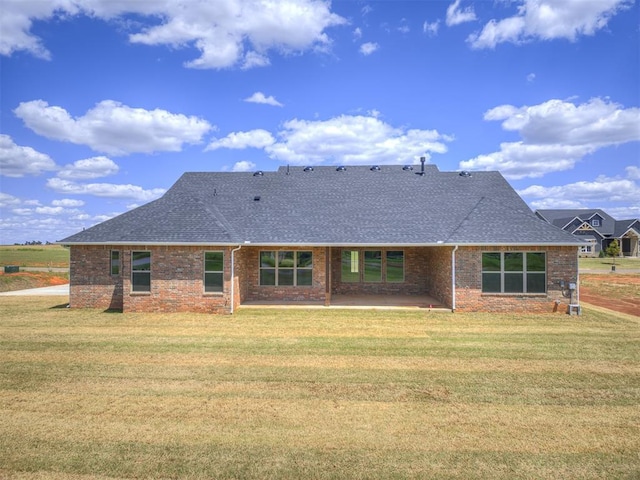 6841 Lake View Ct, Cashion, OK 73016 - rear view of property with roof with shingles, a patio area, brick siding, and a lawn
