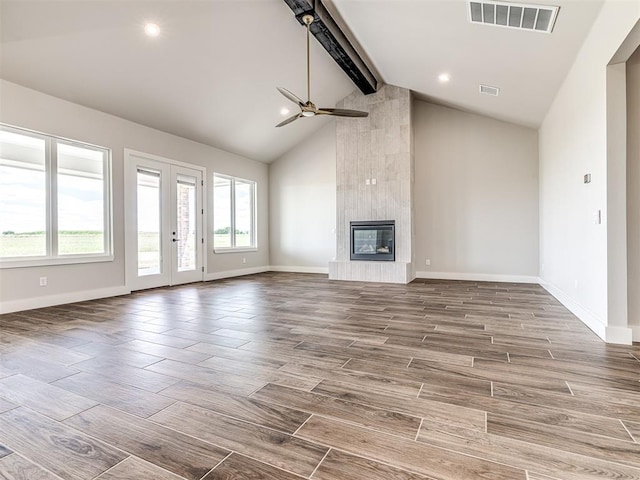 6860 Lake View Ct, Cashion, OK 73016 - unfurnished living room with a ceiling fan, baseboards, healthy amount of natural light, beam ceiling, and wood finished floors