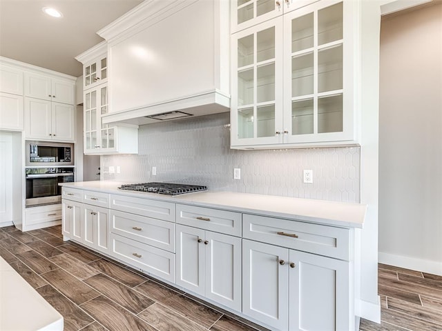 6860 Lake View Ct, Cashion, OK 73016 - kitchen featuring stainless steel appliances, light countertops, backsplash, white cabinets, and dark wood-style floors