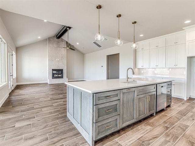 6860 Lake View Ct, Cashion, OK 73016 - kitchen with dishwasher, a sink, wood finish floors, gray cabinets, and white cabinets