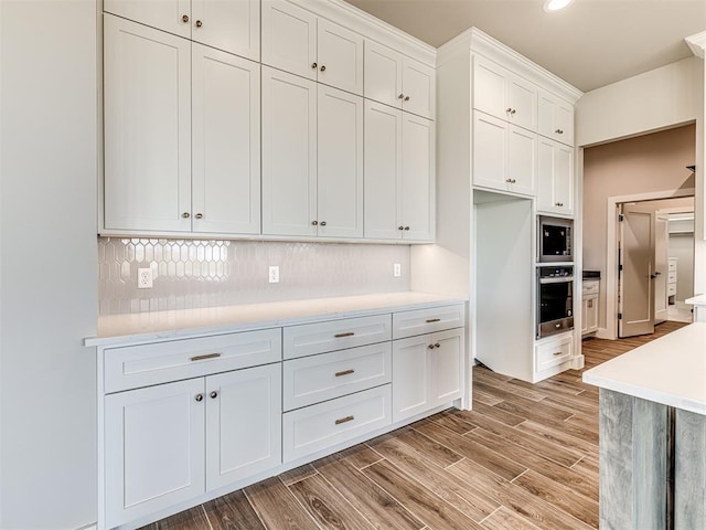 6860 Lake View Ct, Cashion, OK 73016 - kitchen featuring appliances with stainless steel finishes, light countertops, backsplash, light wood-style flooring, and recessed lighting