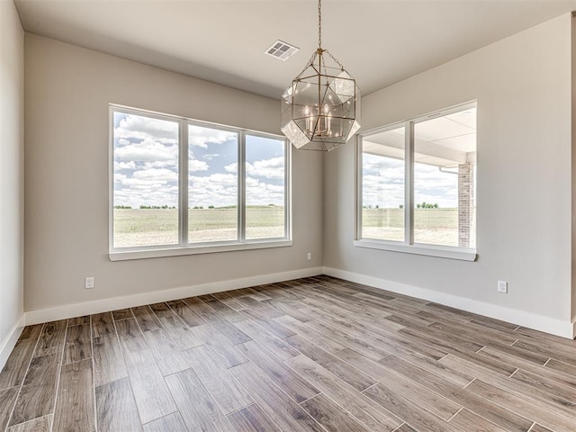 6860 Lake View Ct, Cashion, OK 73016 - empty room featuring a chandelier, wood finished floors, and baseboards
