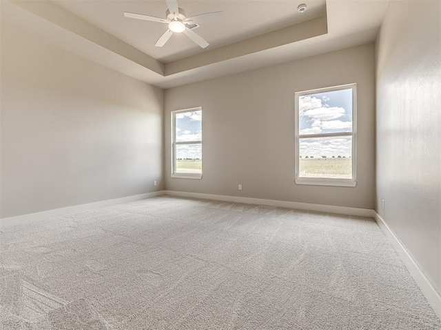 6860 Lake View Ct, Cashion, OK 73016 - empty room featuring plenty of natural light, light carpet, a ceiling fan, and baseboards