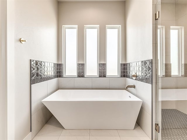 6860 Lake View Ct, Cashion, OK 73016 - full bath featuring a freestanding tub and marble finish flooring