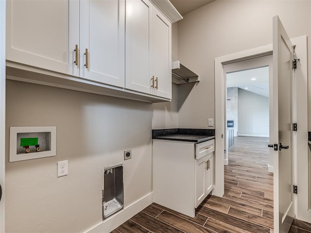 6860 Lake View Ct, Cashion, OK 73016 - washroom with cabinet space, dark wood-style floors, hookup for an electric dryer, hookup for a washing machine, and baseboards