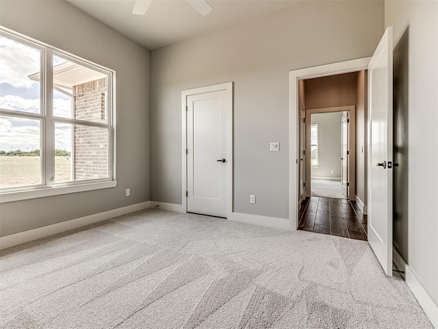6860 Lake View Ct, Cashion, OK 73016 - unfurnished bedroom featuring carpet, baseboards, and a ceiling fan