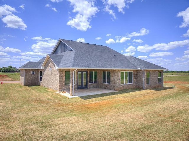 6860 Lake View Ct, Cashion, OK 73016 - rear view of house with brick siding, a shingled roof, a lawn, a patio, and board and batten siding