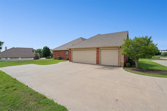 607 Pool Pl, Shawnee, OK 74801 - view of property exterior featuring brick siding, concrete driveway, a yard, and a garage