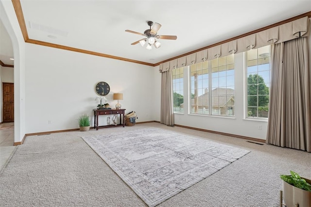 607 Pool Pl, Shawnee, OK 74801 - unfurnished room with ornamental molding, light colored carpet, ceiling fan, and arched walkways