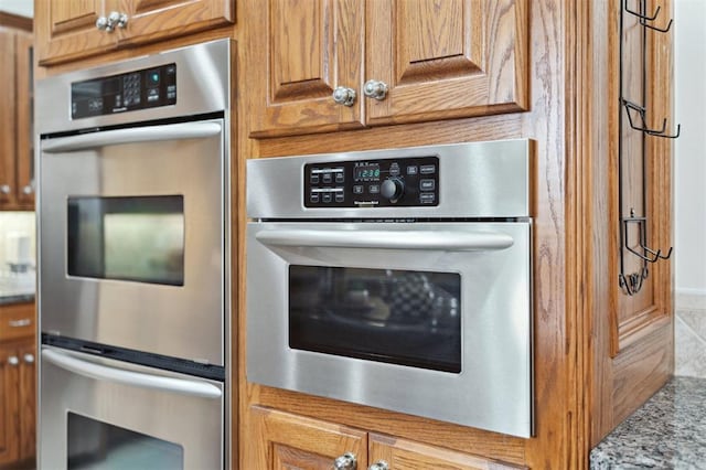 607 Pool Pl, Shawnee, OK 74801 - kitchen featuring stainless steel double oven and brown cabinetry
