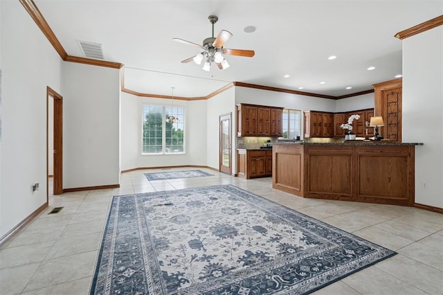 607 Pool Pl, Shawnee, OK 74801 - kitchen with healthy amount of natural light, crown molding, ceiling fan, light tile patterned floors, and dark countertops