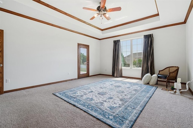 607 Pool Pl, Shawnee, OK 74801 - living area featuring carpet floors, ceiling fan, a tray ceiling, and ornamental molding