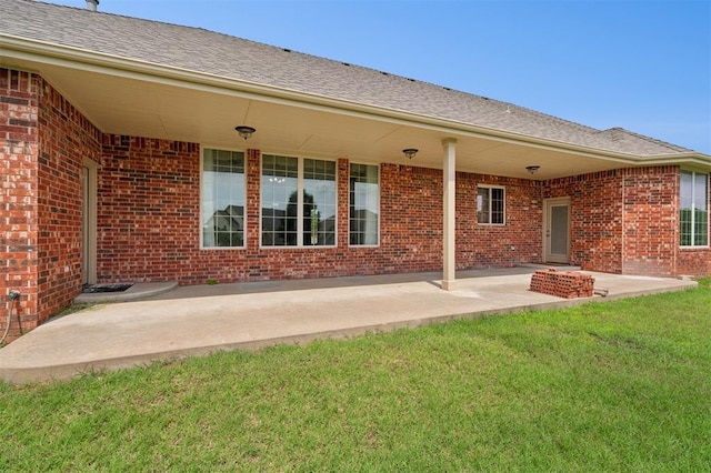 607 Pool Pl, Shawnee, OK 74801 - back of house featuring brick siding, a patio, and a yard