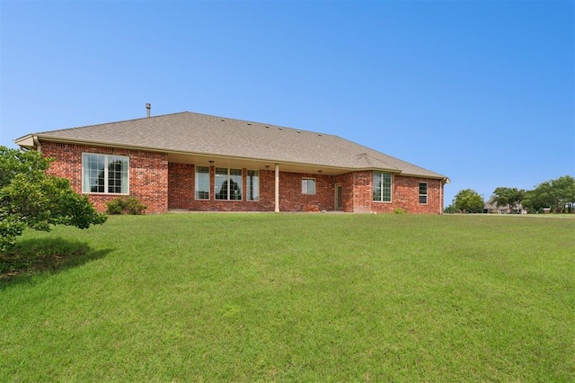 607 Pool Pl, Shawnee, OK 74801 - rear view of house with a yard and brick siding