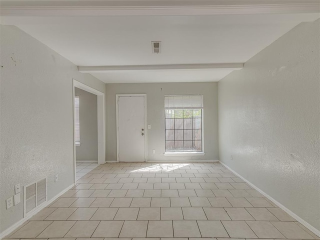 2720 SW 74th St Unit 6, Oklahoma City, OK 73159 - spare room with baseboards, beamed ceiling, and a textured wall