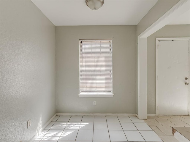 2720 SW 74th St Unit 6, Oklahoma City, OK 73159 - tiled spare room featuring plenty of natural light and baseboards