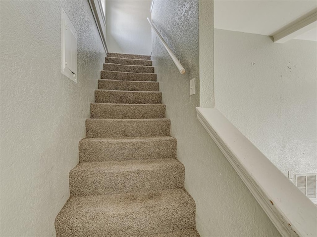 2720 SW 74th St Unit 6, Oklahoma City, OK 73159 - stairs with a textured wall