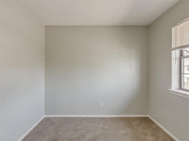 2720 SW 74th St Unit 6, Oklahoma City, OK 73159 - empty room with carpet, baseboards, and a textured ceiling