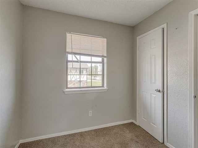 2720 SW 74th St Unit 6, Oklahoma City, OK 73159 - unfurnished bedroom with carpet, baseboards, and a textured ceiling