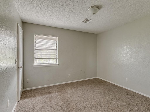 2720 SW 74th St Unit 6, Oklahoma City, OK 73159 - carpeted spare room with a textured ceiling and baseboards