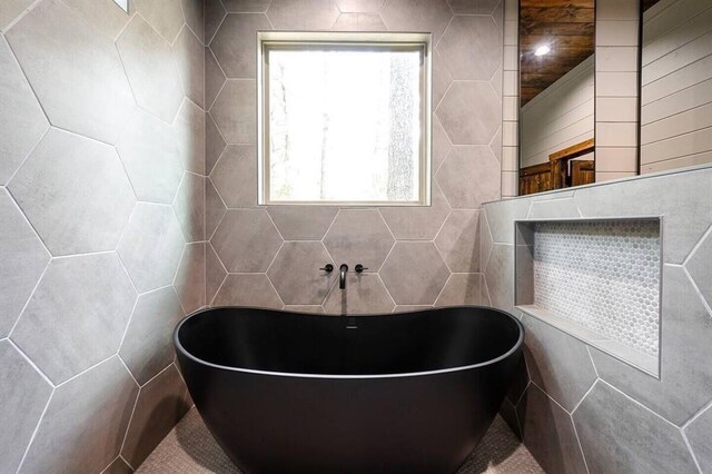 172 Triton Trl, Broken Bow, OK 74728 - bathroom with tile walls and a freestanding bath