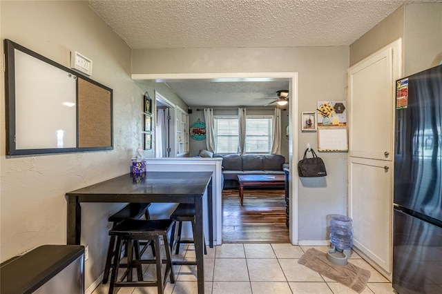 840 NW 14th St, Moore, OK 73160 - dining space with a textured ceiling, ceiling fan, light tile patterned floors, and a textured wall