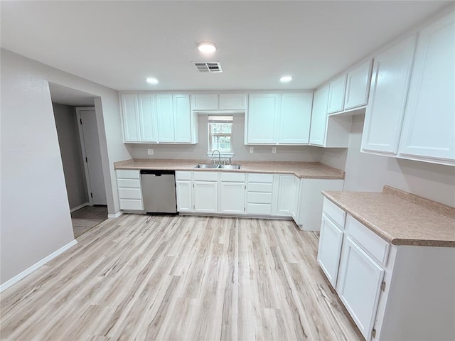 402 E 6th St, Amber, OK 73004 - kitchen with stainless steel dishwasher, a sink, white cabinetry, light wood-style flooring, and baseboards