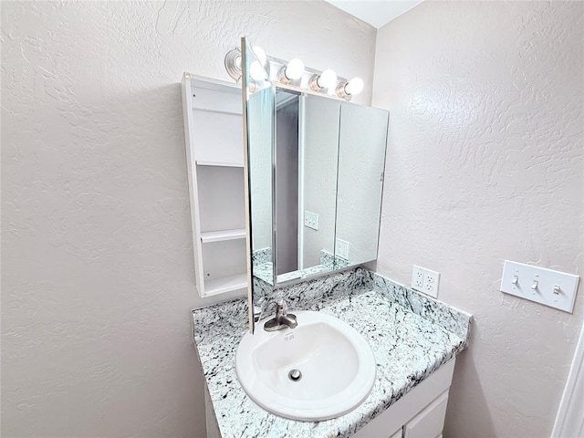 402 E 6th St, Amber, OK 73004 - bathroom featuring a textured wall and vanity