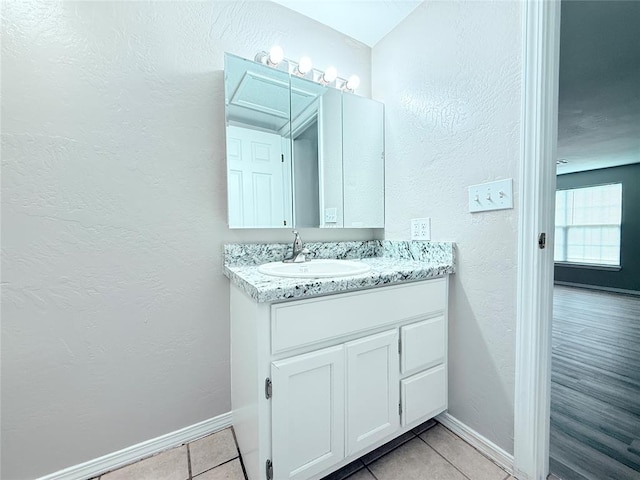 402 E 6th St, Amber, OK 73004 - bathroom with vanity, a textured wall, baseboards, and tile patterned floors