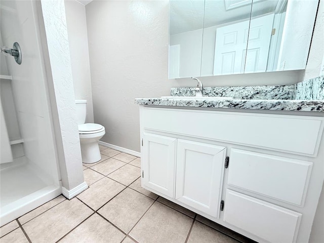 402 E 6th St, Amber, OK 73004 - full bathroom with vanity, toilet, tile patterned floors, baseboards, and a shower stall
