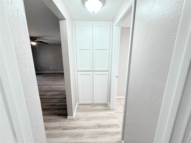 402 E 6th St, Amber, OK 73004 - hall with light wood-type flooring, a textured wall, and baseboards