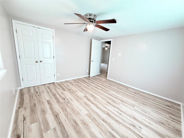 402 E 6th St, Amber, OK 73004 - unfurnished bedroom with light wood-style flooring, a closet, ceiling fan, and baseboards