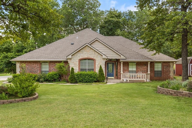 10650 Hunters Pointe, Edmond, OK 73034 - view of front facade with a front yard, a shingled roof, covered porch, and brick siding